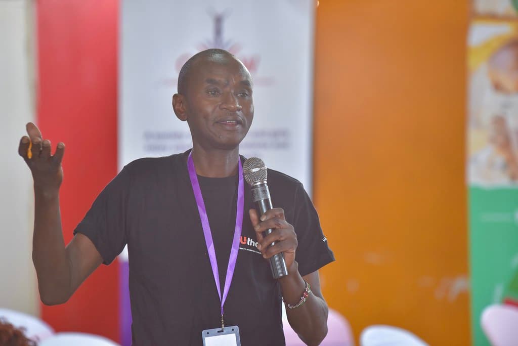 Uthabiti representative addressing a community convening